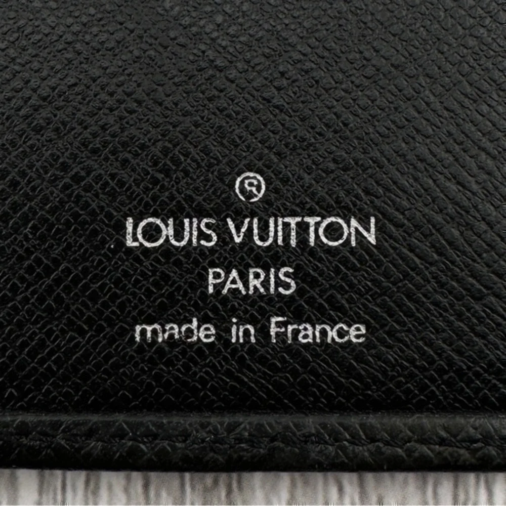 AUTHENTIC Louis Vuitton Taiga wallet. Previously owned. Color: Black.